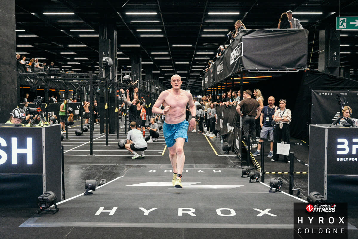 Age-group HYROX athlete running between race stations
