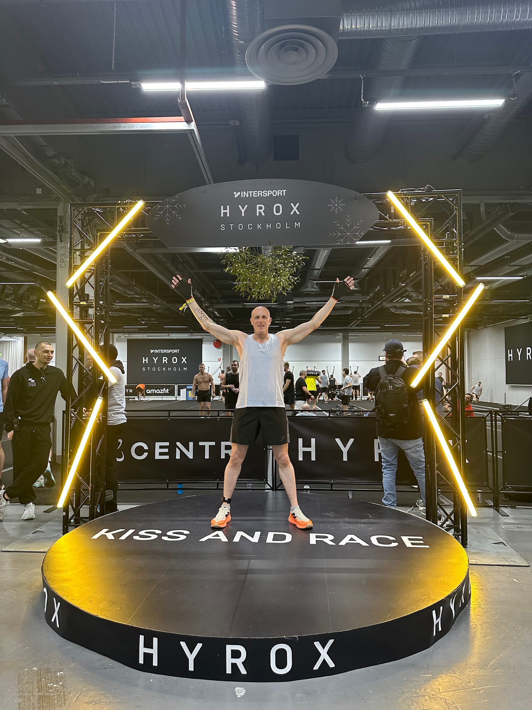 Age-group HYROX athlete standing under the HYROX Stockholm race arch